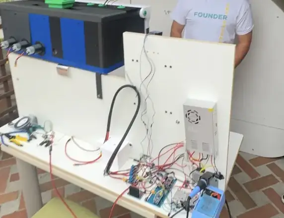 Omelette Bot prototype: ingredient dispensers, control electronics and assembly bench, from the pitch deck.